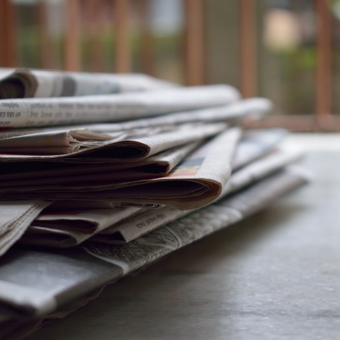 Stack of newspaper, representing "media"